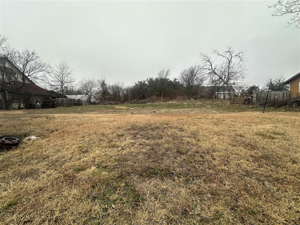 408 Cedar Street Hico, TX 76457 - Photo 2 of 2 a view of a field with trees in background