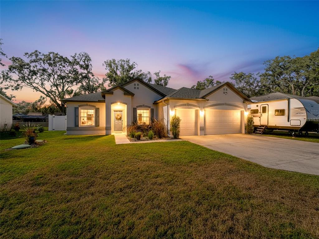 a front view of a house with a garden