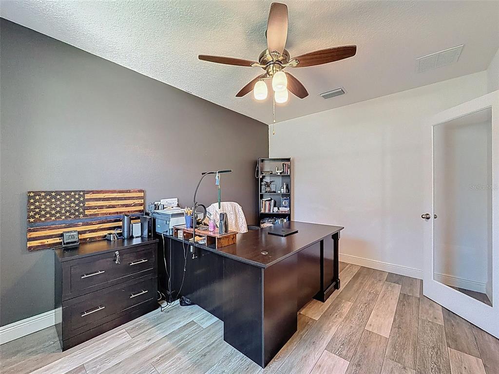 237 Leafy Way Avenue Spring Hill, FL 34606 - Photo 11 of 68 a living room with furniture and a wooden floor