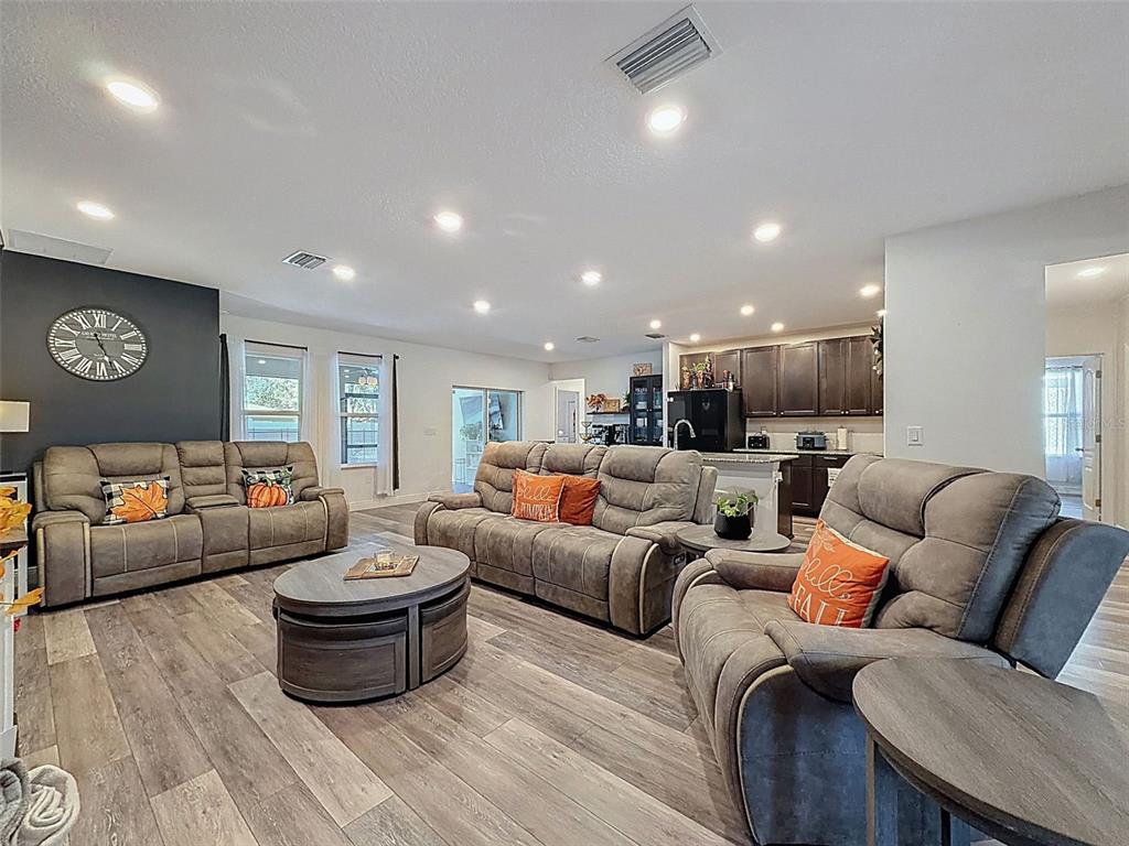 237 Leafy Way Avenue Spring Hill, FL 34606 - Photo 12 of 68 a living room with furniture and a view of kitchen