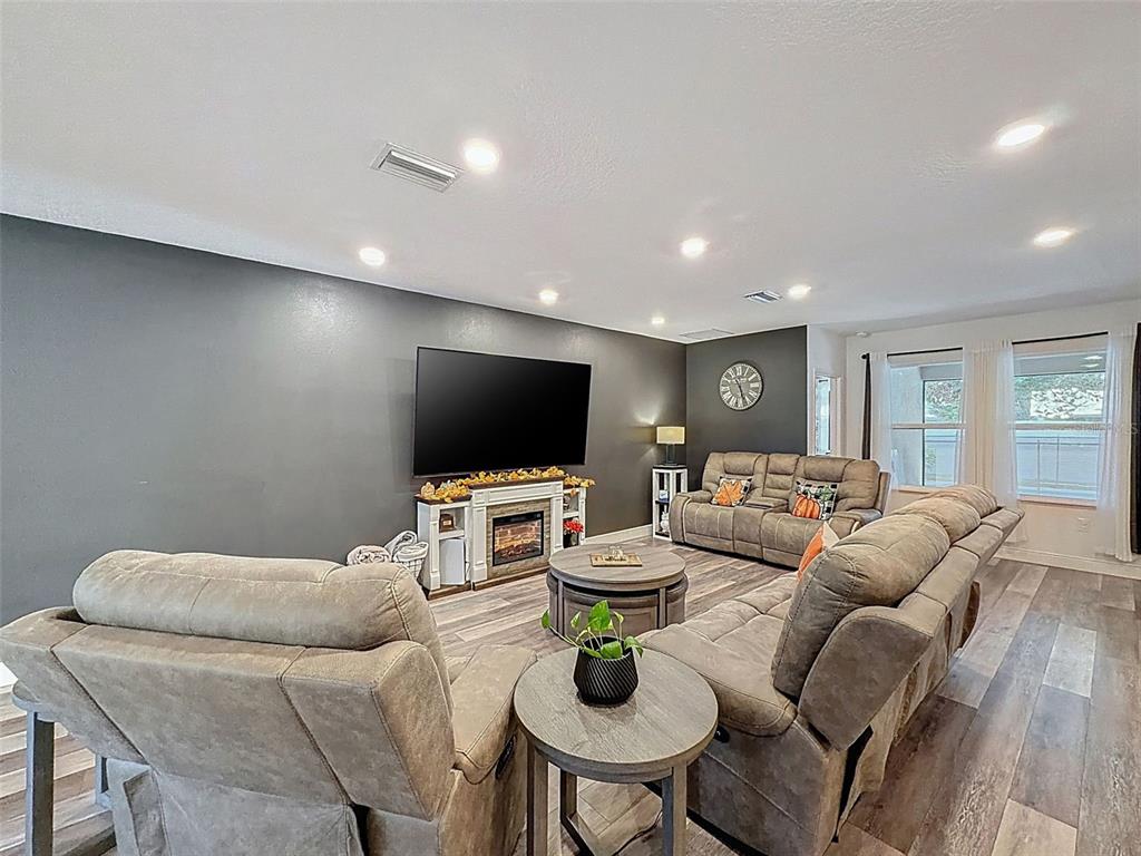 237 Leafy Way Avenue Spring Hill, FL 34606 - Photo 14 of 68 a living room with furniture and a flat screen tv