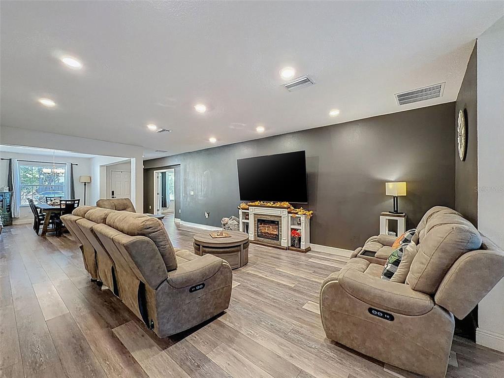 237 Leafy Way Avenue Spring Hill, FL 34606 - Photo 15 of 68 a living room with furniture and a flat screen tv