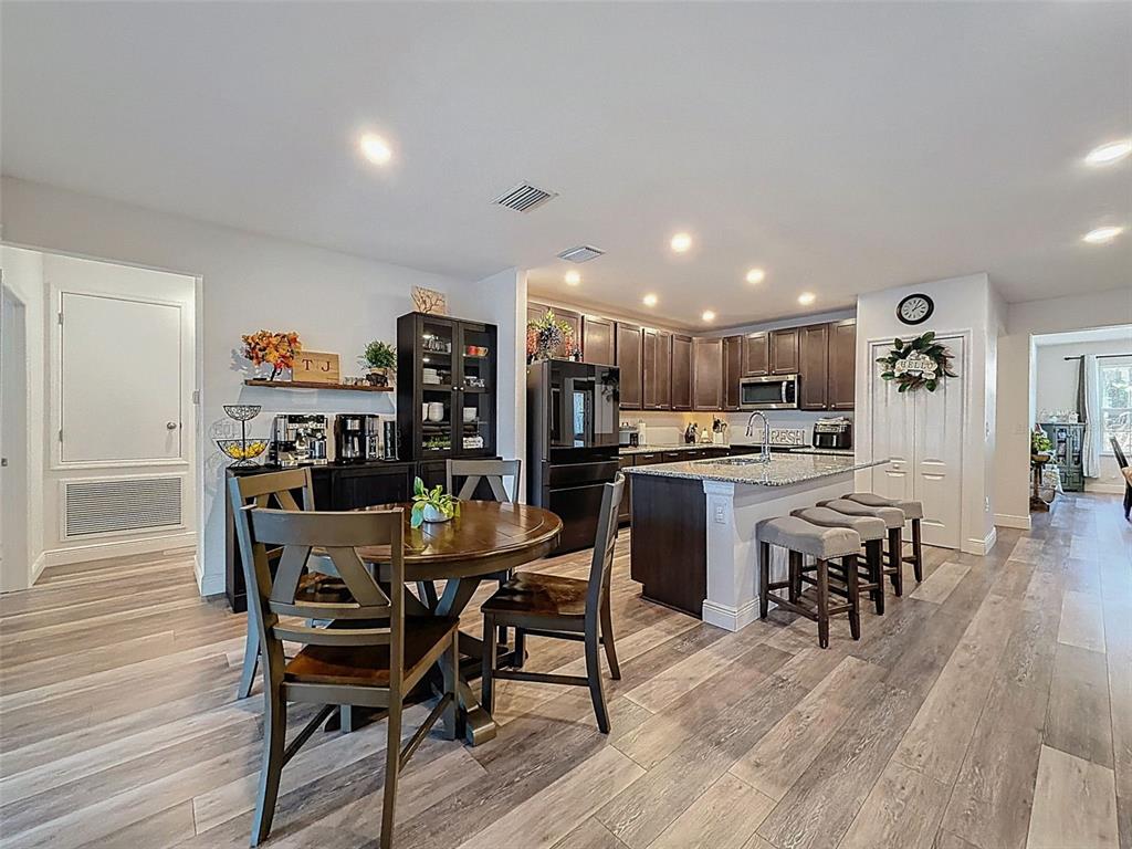 237 Leafy Way Avenue Spring Hill, FL 34606 - Photo 16 of 68 a view of a dining room with furniture and wooden floor