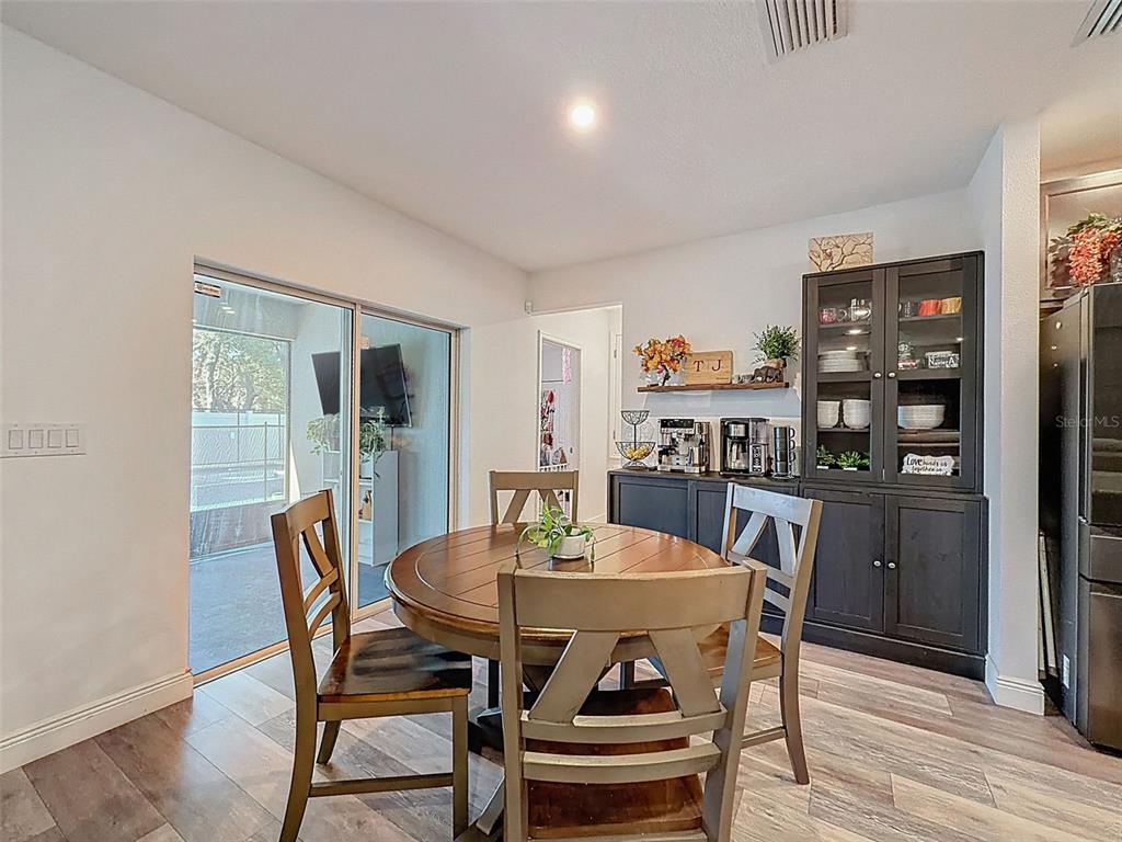 237 Leafy Way Avenue Spring Hill, FL 34606 - Photo 18 of 68 a view of a dining room with furniture and wooden floor