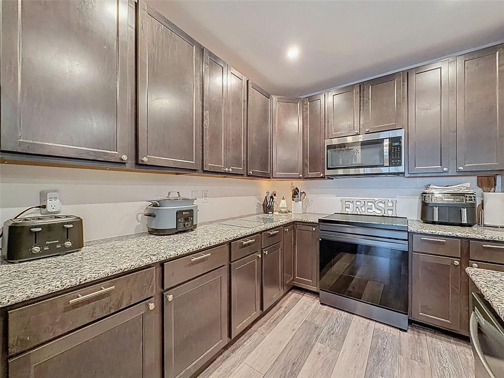 237 Leafy Way Avenue Spring Hill, FL 34606 - Photo 22 of 68 a kitchen with granite countertop stainless steel appliances and cabinets