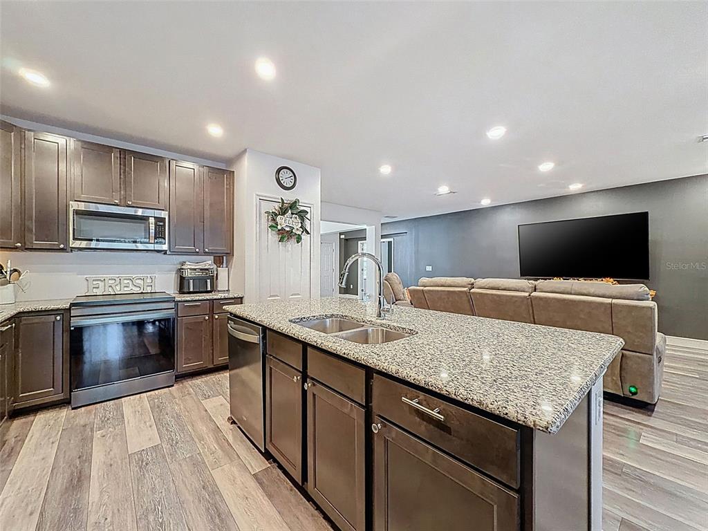 237 Leafy Way Avenue Spring Hill, FL 34606 - Photo 23 of 68 a kitchen with a center island and stainless steel appliances