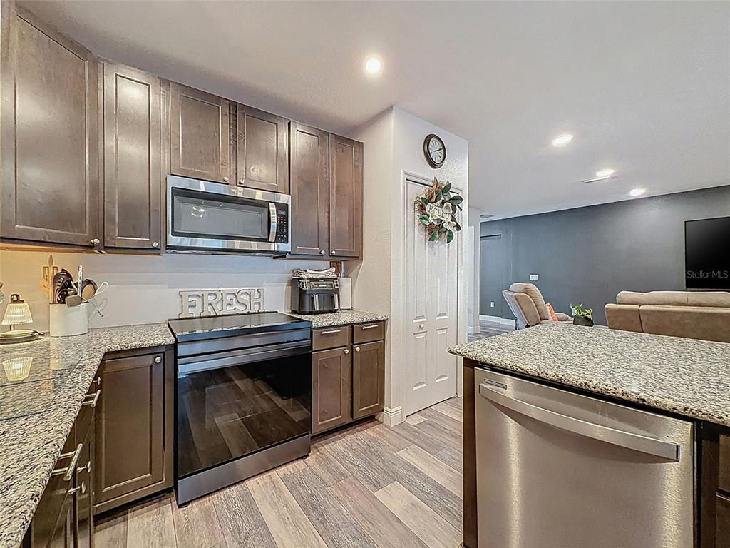 237 Leafy Way Avenue Spring Hill, FL 34606 - Photo 24 of 68 a kitchen with kitchen island granite countertop stainless steel appliances and sink
