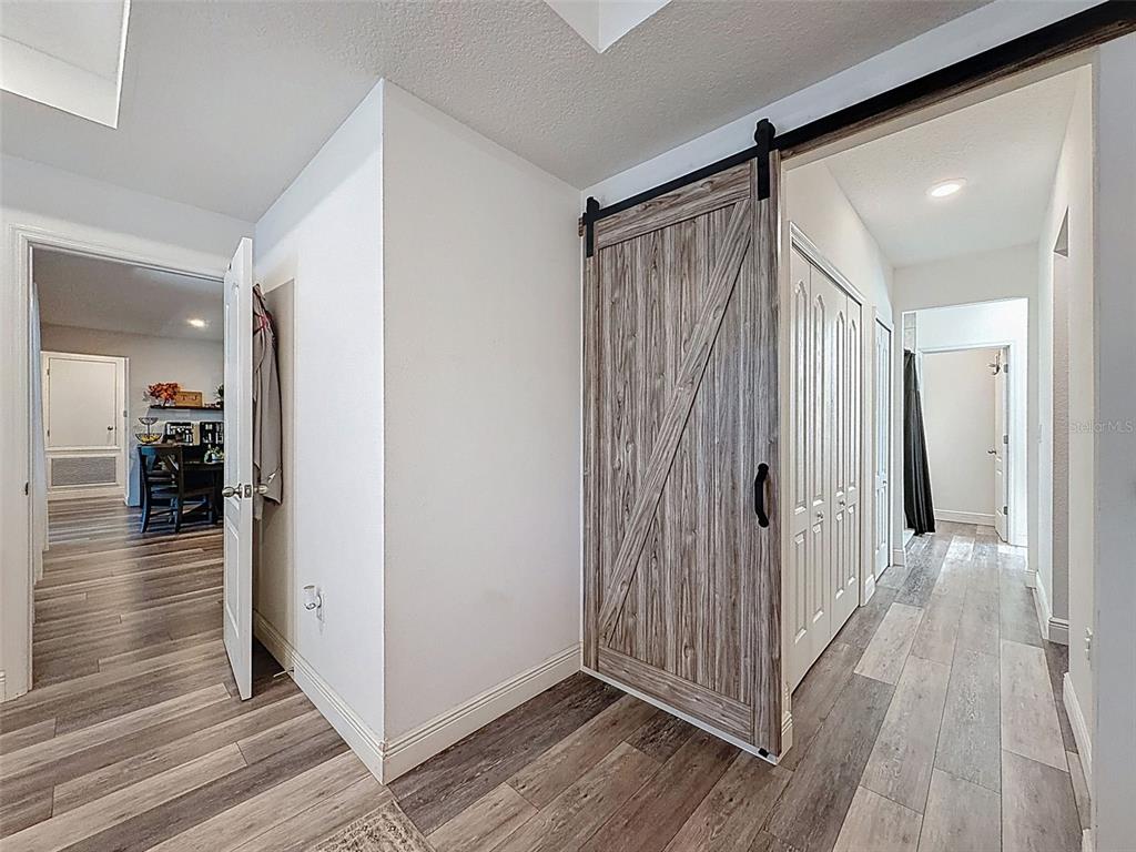 237 Leafy Way Avenue Spring Hill, FL 34606 - Photo 28 of 68 a view of a hallway with wooden floor and staircase