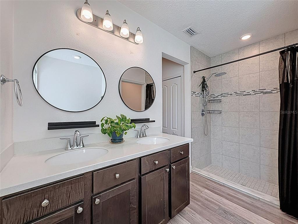 237 Leafy Way Avenue Spring Hill, FL 34606 - Photo 29 of 68 a bathroom with a double vanity sink and a mirror