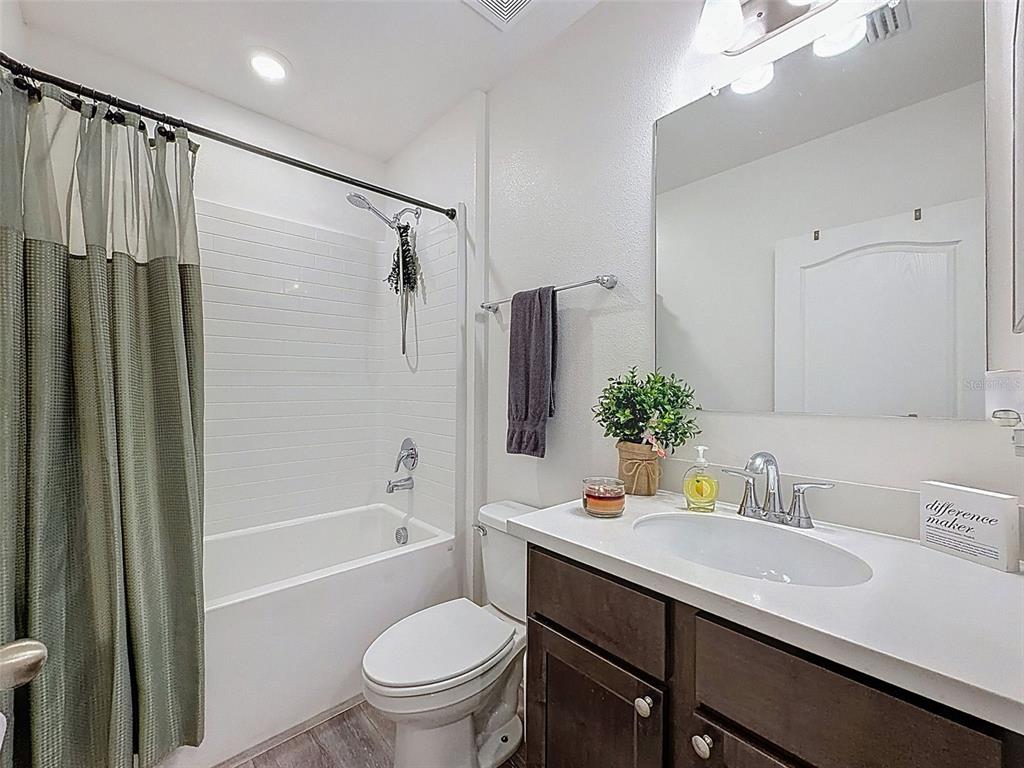 237 Leafy Way Avenue Spring Hill, FL 34606 - Photo 33 of 68 a bathroom with a granite countertop sink toilet and shower