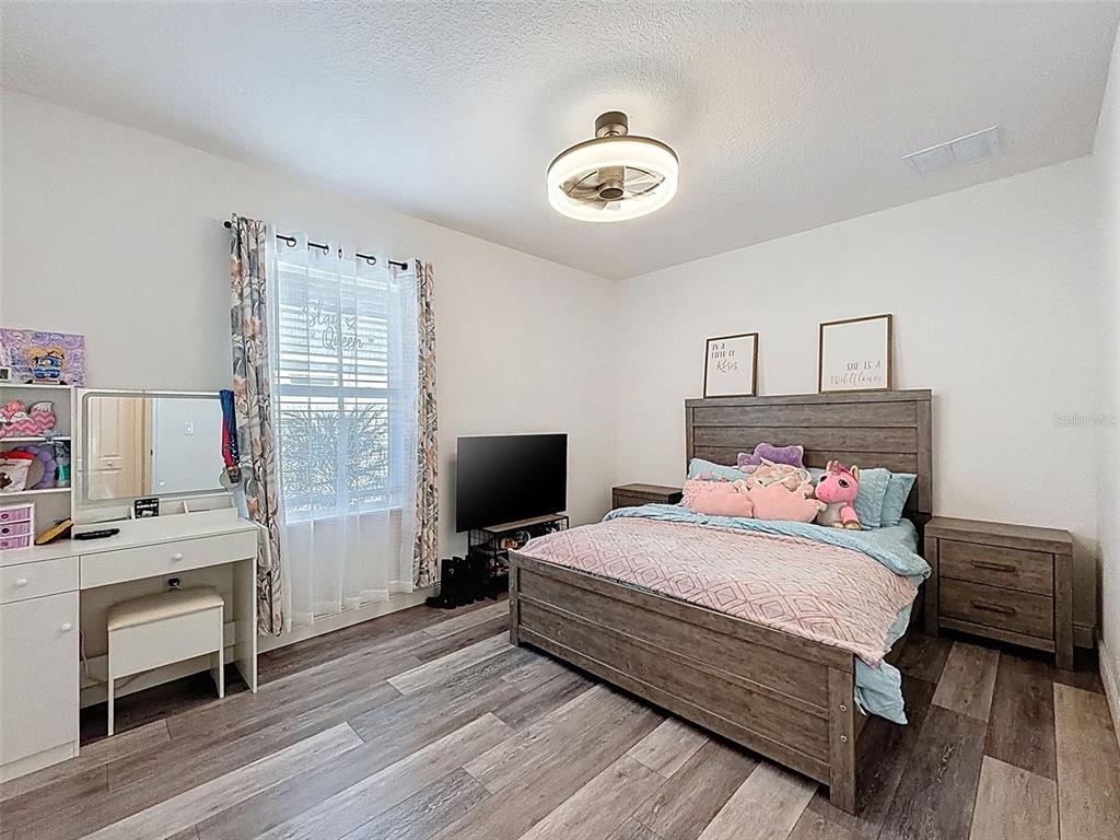 237 Leafy Way Avenue Spring Hill, FL 34606 - Photo 34 of 68 a bedroom with a bed and a flat screen tv