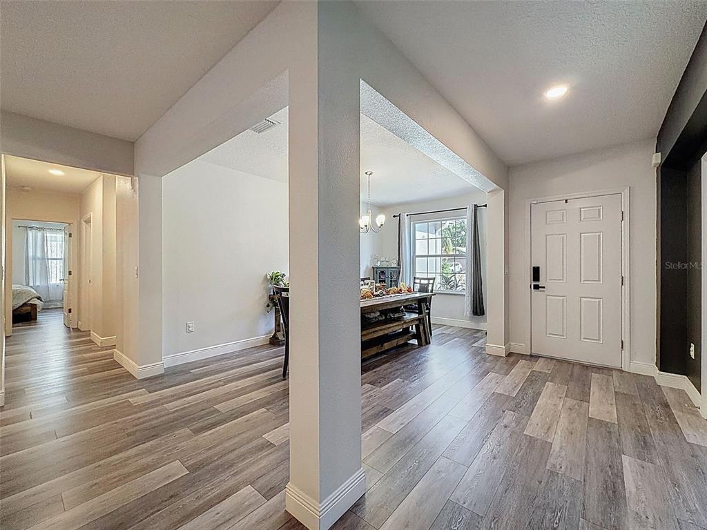 237 Leafy Way Avenue Spring Hill, FL 34606 - Photo 4 of 68 a view of a livingroom with wooden floor and furniture