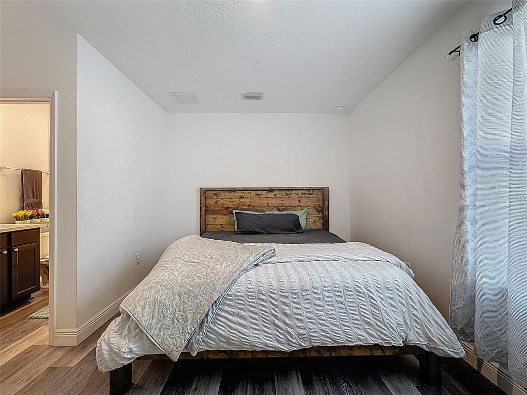 237 Leafy Way Avenue Spring Hill, FL 34606 - Photo 43 of 68 a bedroom with a bed and wooden floor