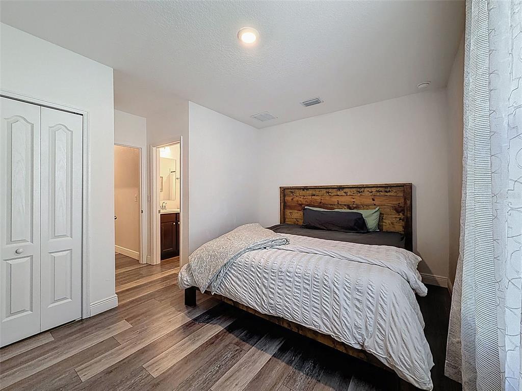237 Leafy Way Avenue Spring Hill, FL 34606 - Photo 44 of 68 a bedroom with a bed and wooden floor