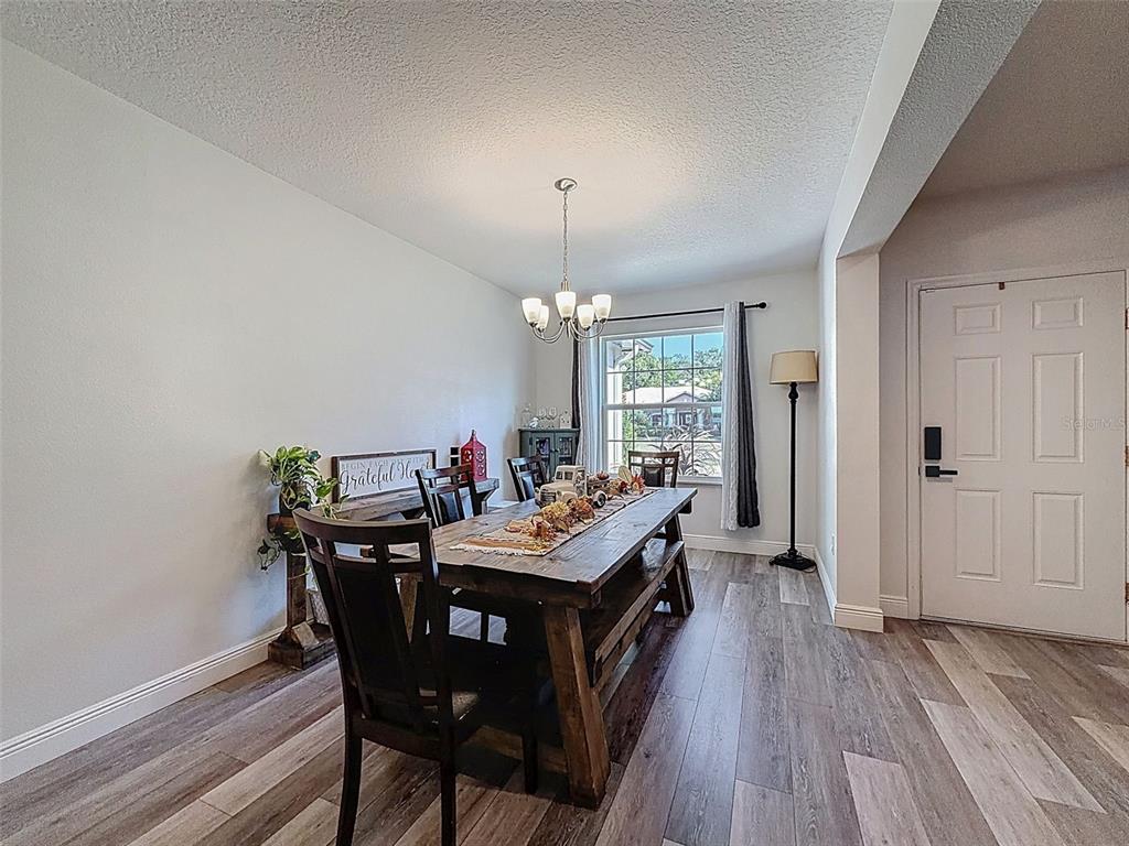 237 Leafy Way Avenue Spring Hill, FL 34606 - Photo 5 of 68 a view of a dining room with furniture window and wooden floor