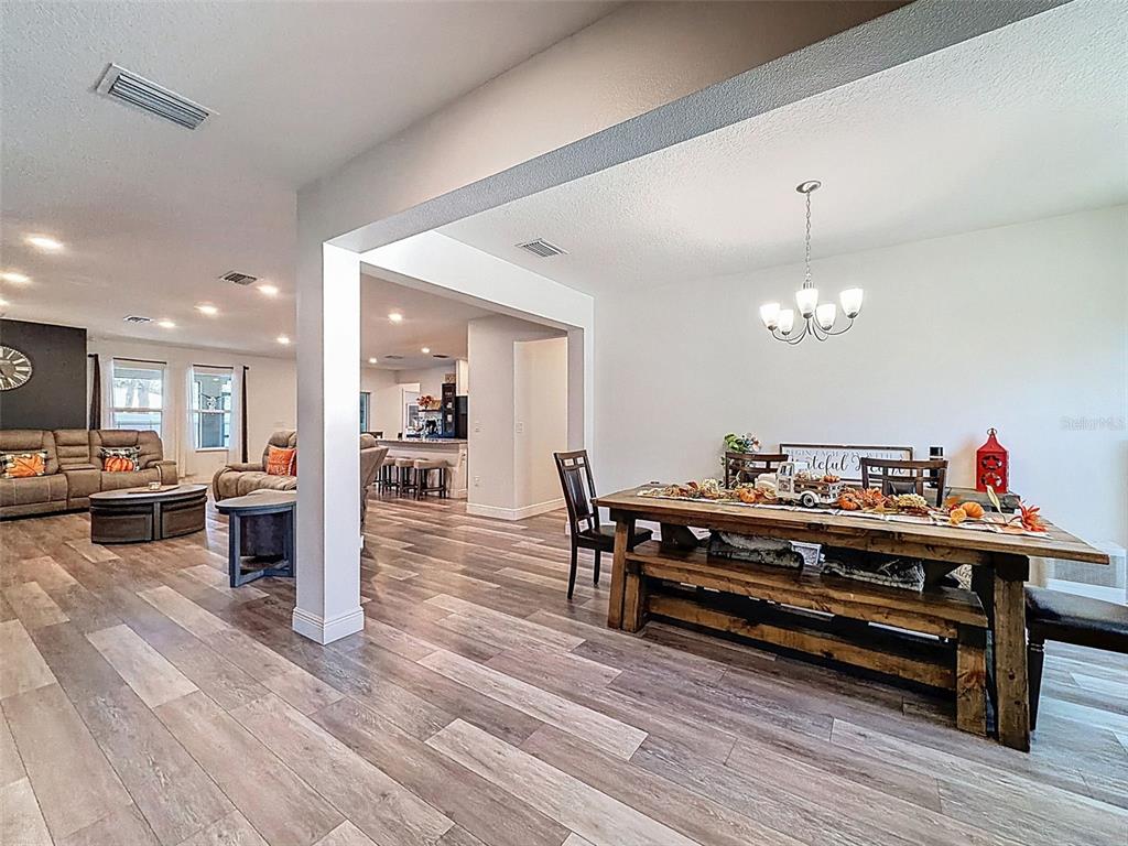 237 Leafy Way Avenue Spring Hill, FL 34606 - Photo 6 of 68 a living room with furniture and a wooden floor