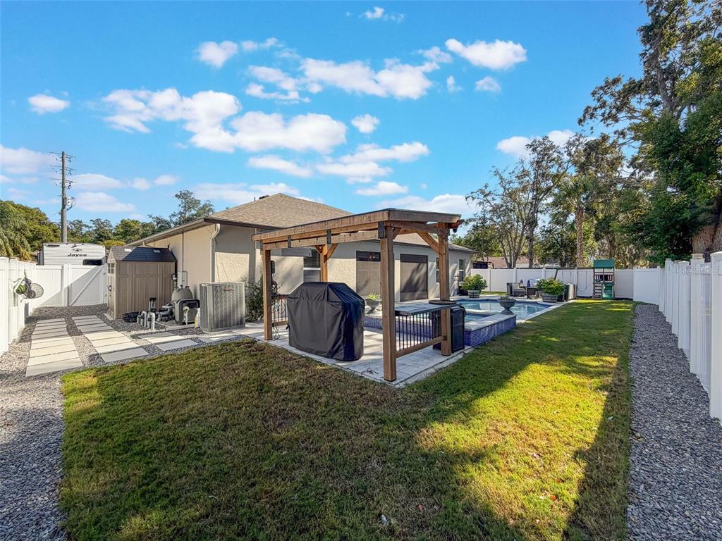 237 Leafy Way Avenue Spring Hill, FL 34606 - Photo 61 of 68 a view of a house with a yard patio and fire pit