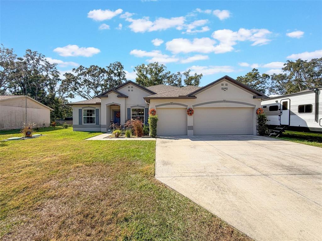 237 Leafy Way Avenue Spring Hill, FL 34606 - Photo 62 of 68 a front view of a house with yard and tree