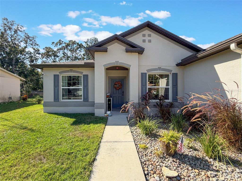 237 Leafy Way Avenue Spring Hill, FL 34606 - Photo 68 of 68 a front view of house with yard and outdoor seating