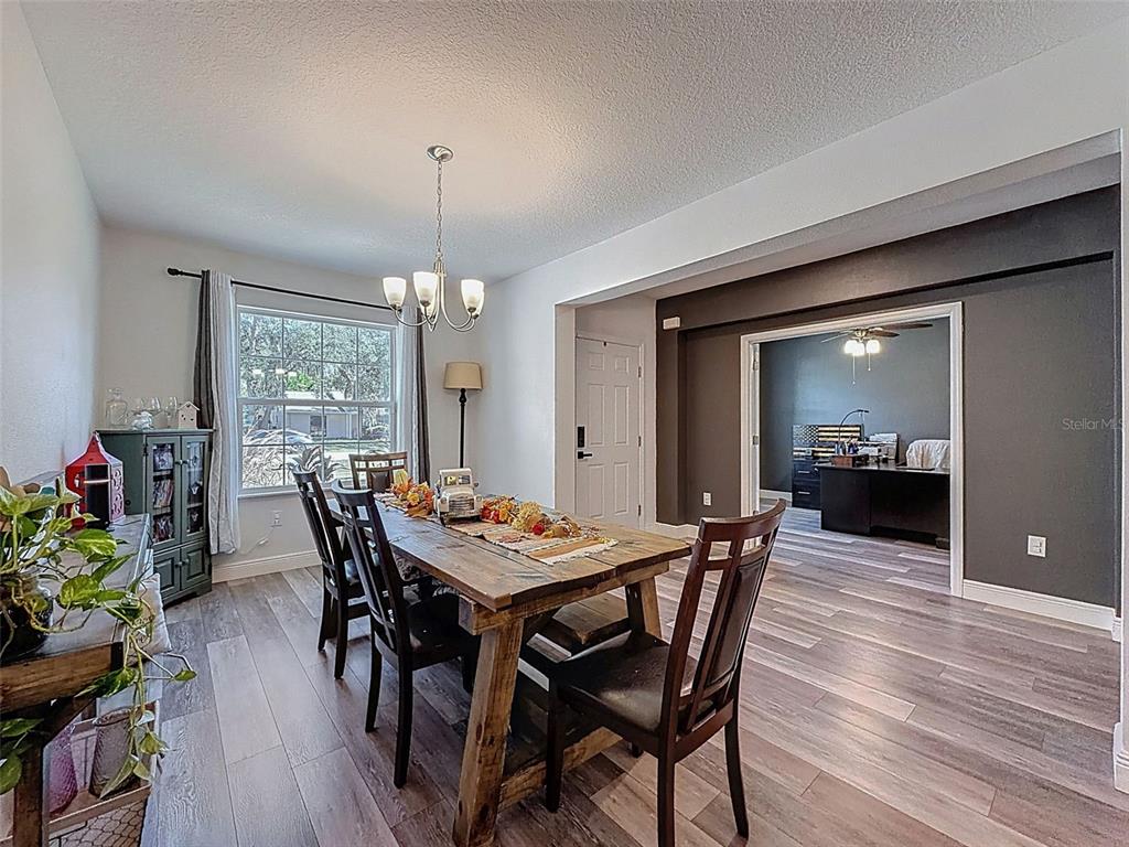 237 Leafy Way Avenue Spring Hill, FL 34606 - Photo 7 of 68 a dining room with furniture window and wooden floor