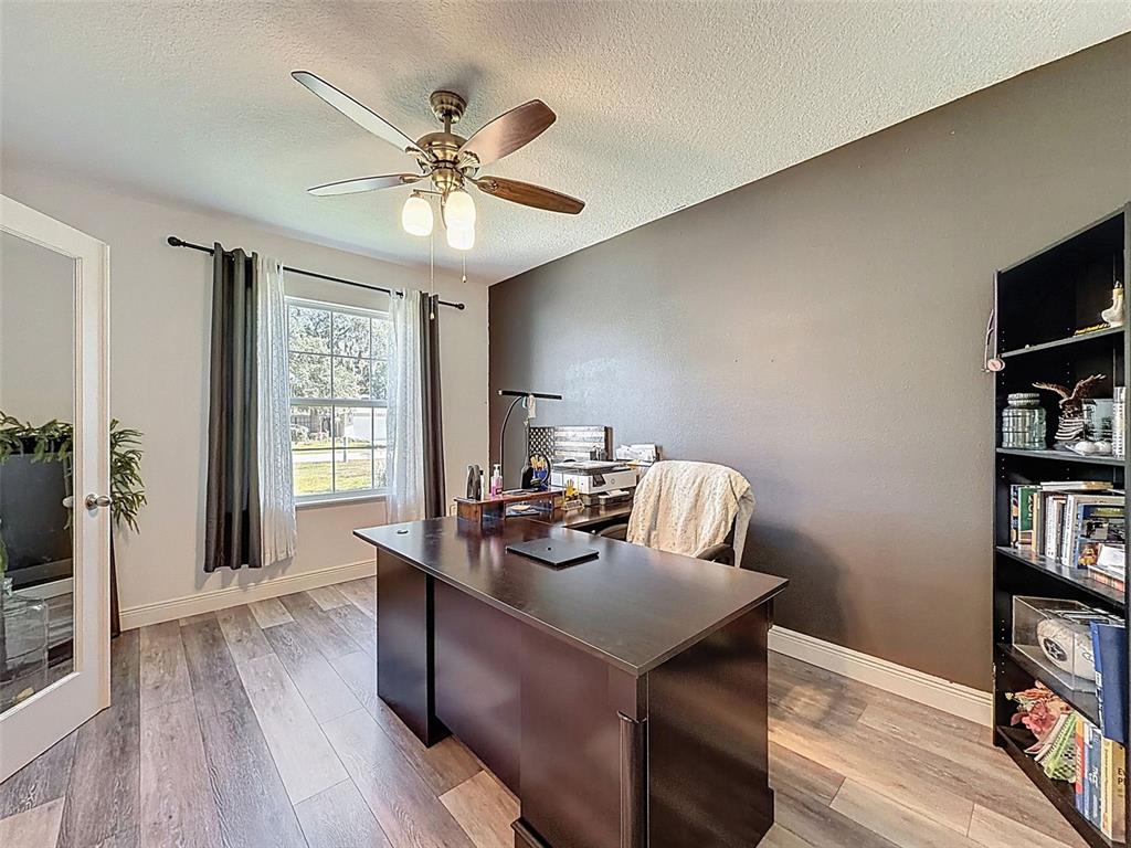 237 Leafy Way Avenue Spring Hill, FL 34606 - Photo 9 of 68 a view of a livingroom with furniture and a ceiling fan