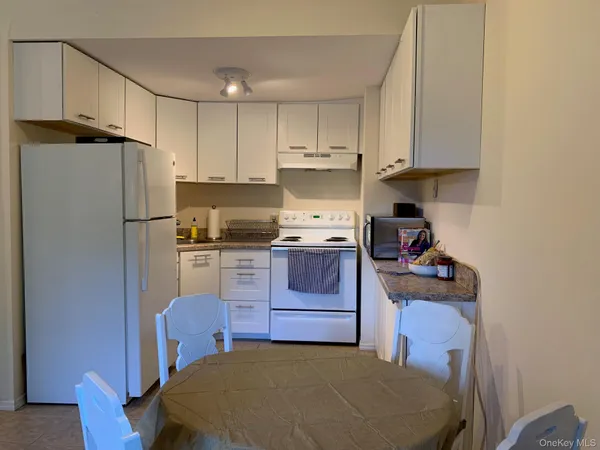a kitchen with a refrigerator and a stove