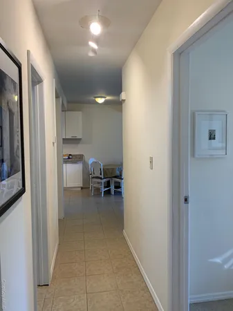 a view of kitchen with refrigerator and chairs