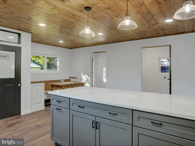 a view of cabinets a sink and dishwasher in a room