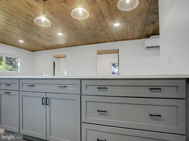 a view of room with window and flowerpot
