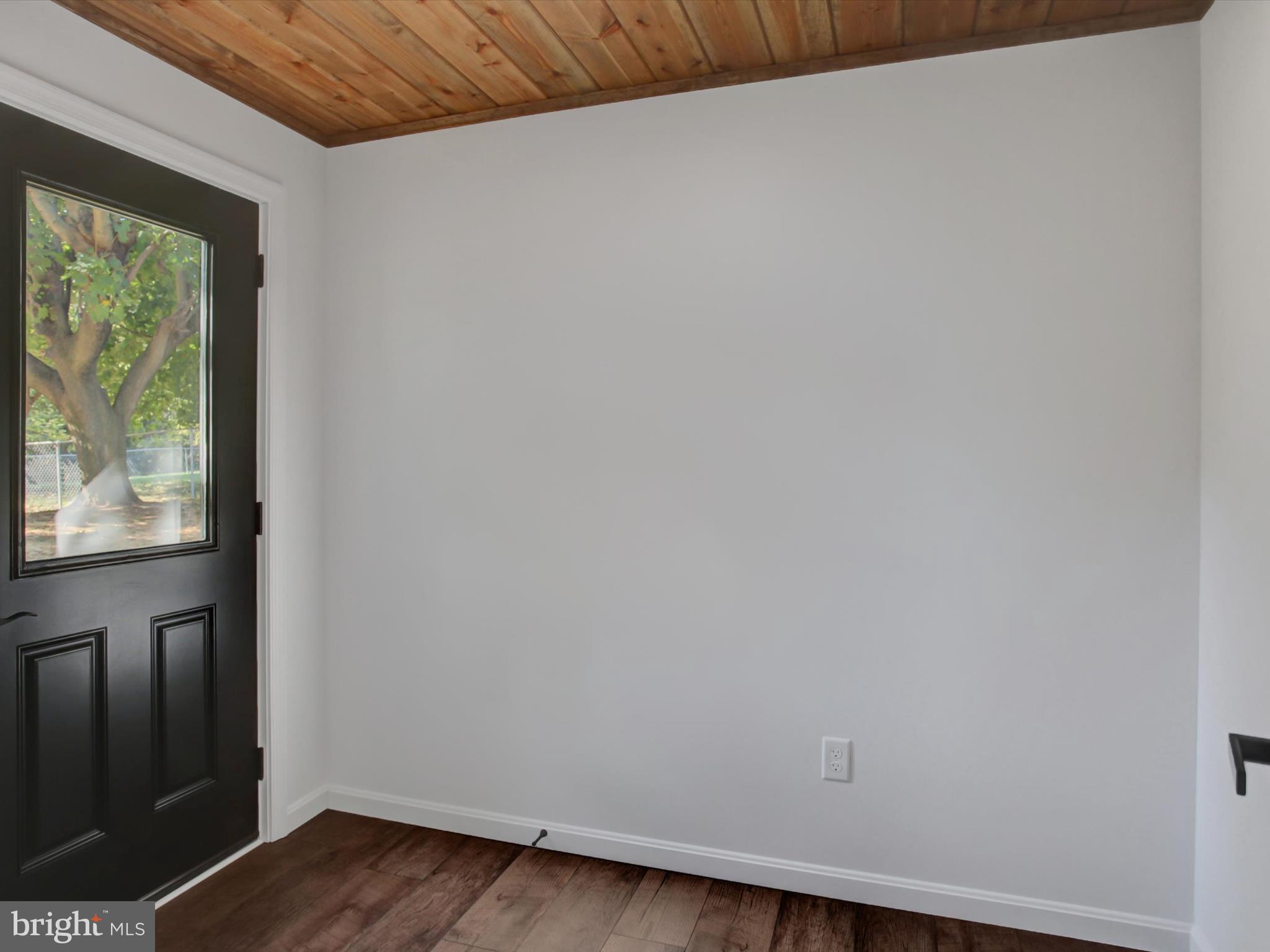 16 East Main Street Newburg, PA 17240 - Photo 21 of 48 a view of an empty room with wooden floor and a window