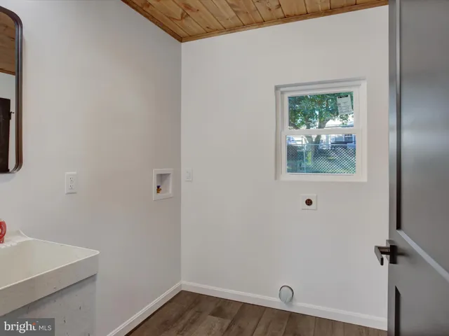 a view of a small space with wooden floor and a window