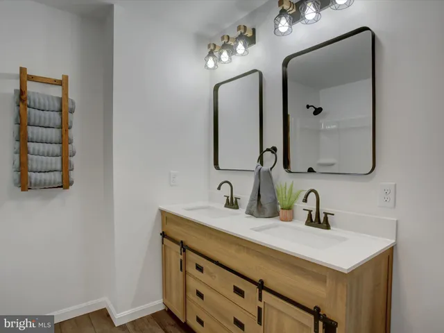 a bathroom with a sink vanity and a mirror