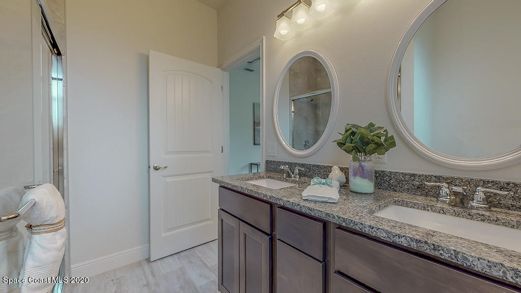 572 Corbin Circle Southwest Palm Bay, FL 32908 - Photo 12 of 32 a bathroom with double vanity sinks and a mirror