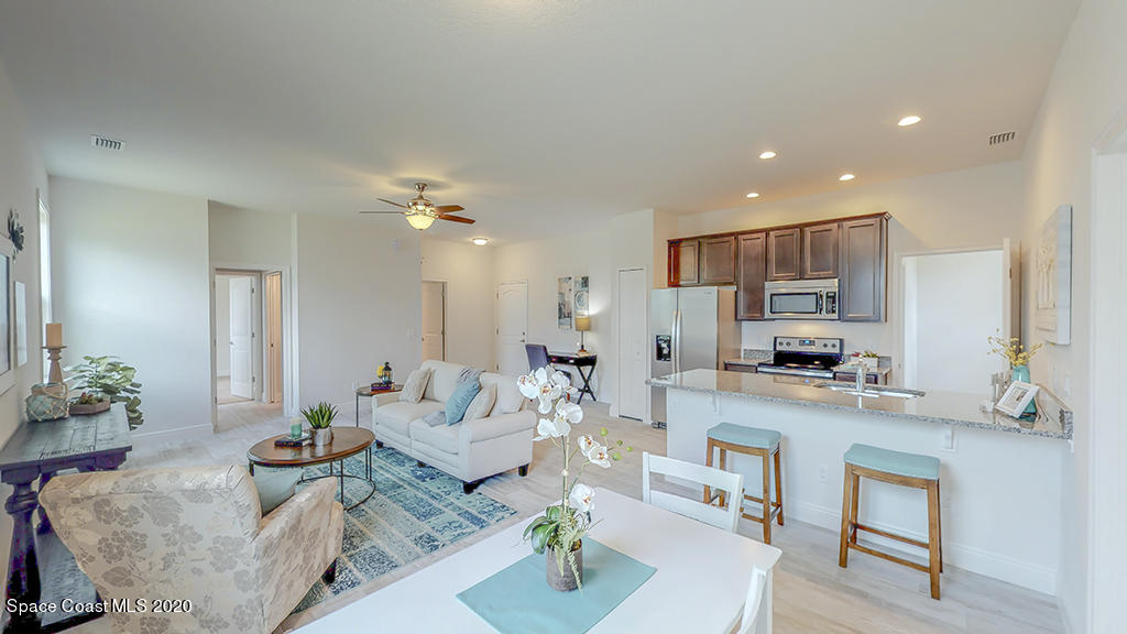 572 Corbin Circle Southwest Palm Bay, FL 32908 - Photo 14 of 32 a living room with furniture and kitchen view