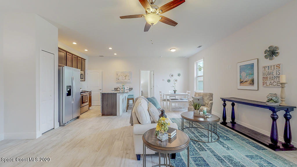572 Corbin Circle Southwest Palm Bay, FL 32908 - Photo 18 of 32 a living room with stainless steel appliances furniture a dining table and a chandelier