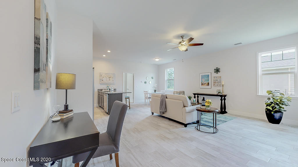 572 Corbin Circle Southwest Palm Bay, FL 32908 - Photo 3 of 32 a living room with furniture and a chandelier