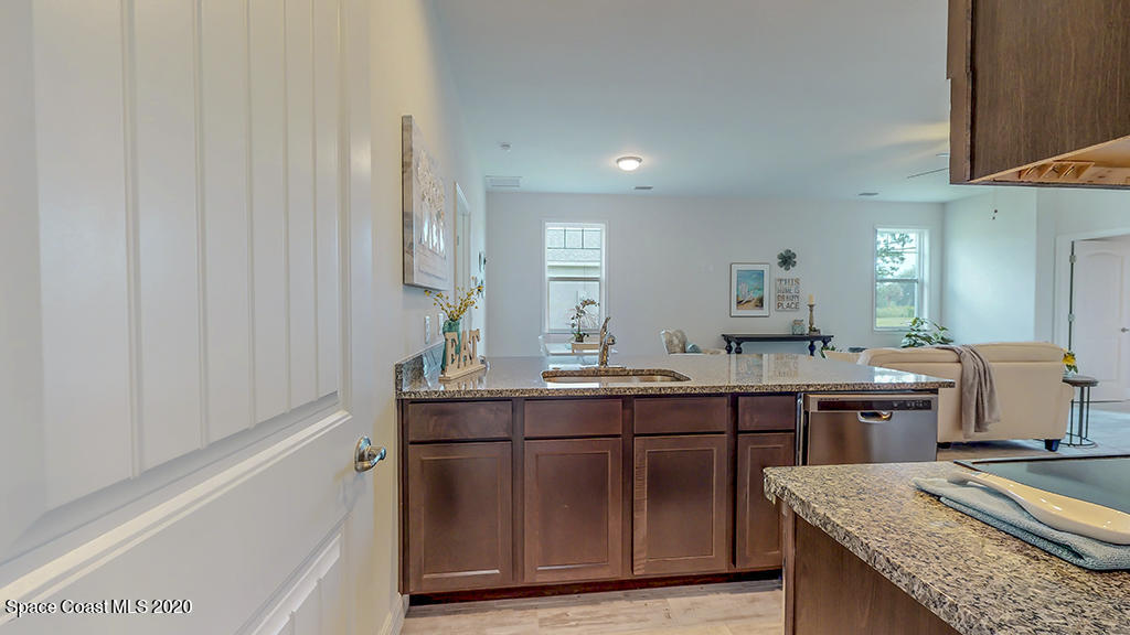 572 Corbin Circle Southwest Palm Bay, FL 32908 - Photo 27 of 32 a kitchen with a sink and cabinets