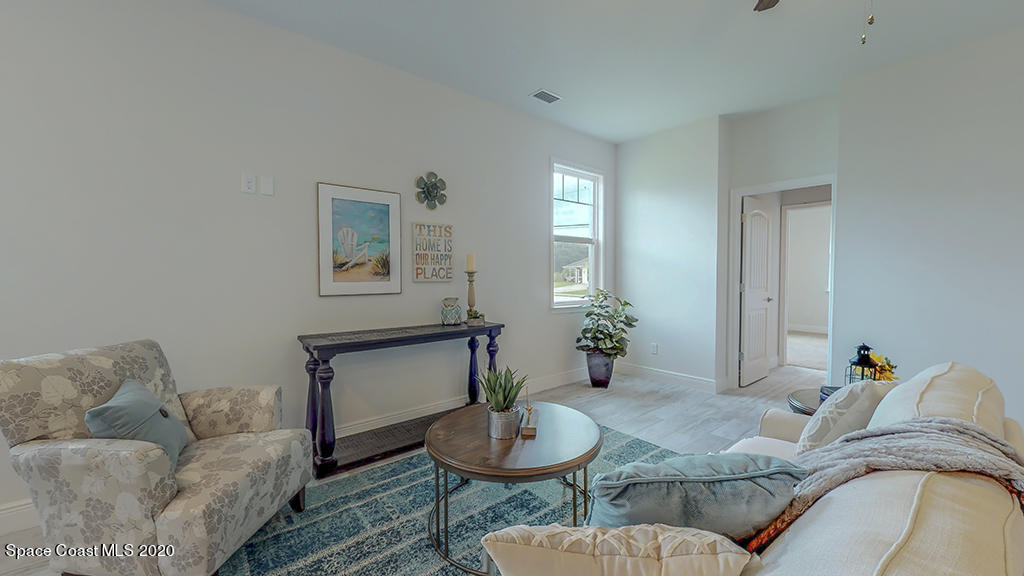 572 Corbin Circle Southwest Palm Bay, FL 32908 - Photo 29 of 32 a living room with furniture and a potted plant
