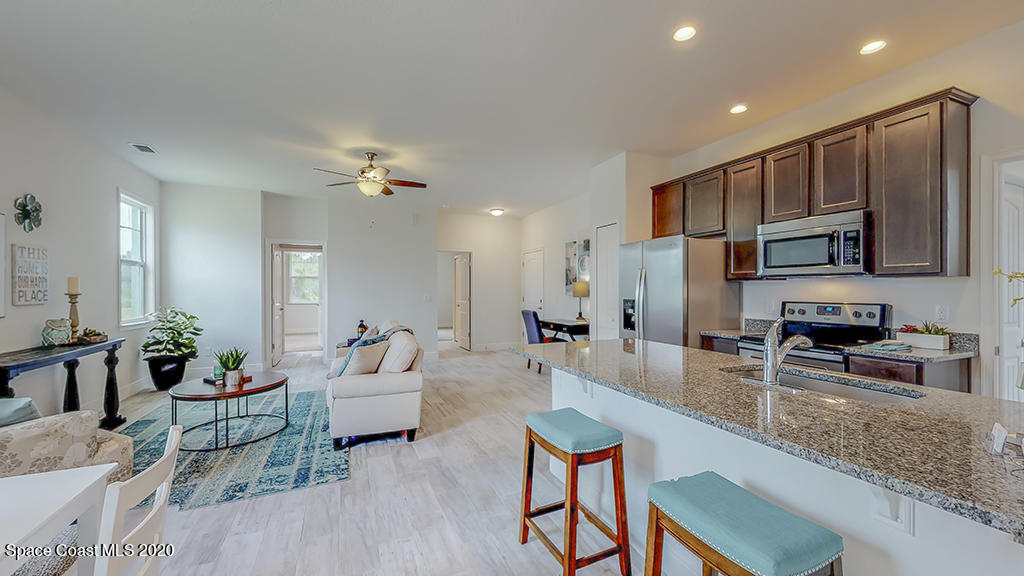 572 Corbin Circle Southwest Palm Bay, FL 32908 - Photo 7 of 32 a living room with furniture kitchen and a table