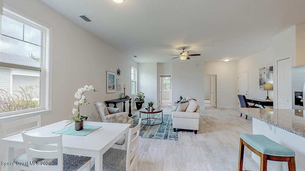 572 Corbin Circle Southwest Palm Bay, FL 32908 - Photo 8 of 32 a living room with furniture a dining table and chairs