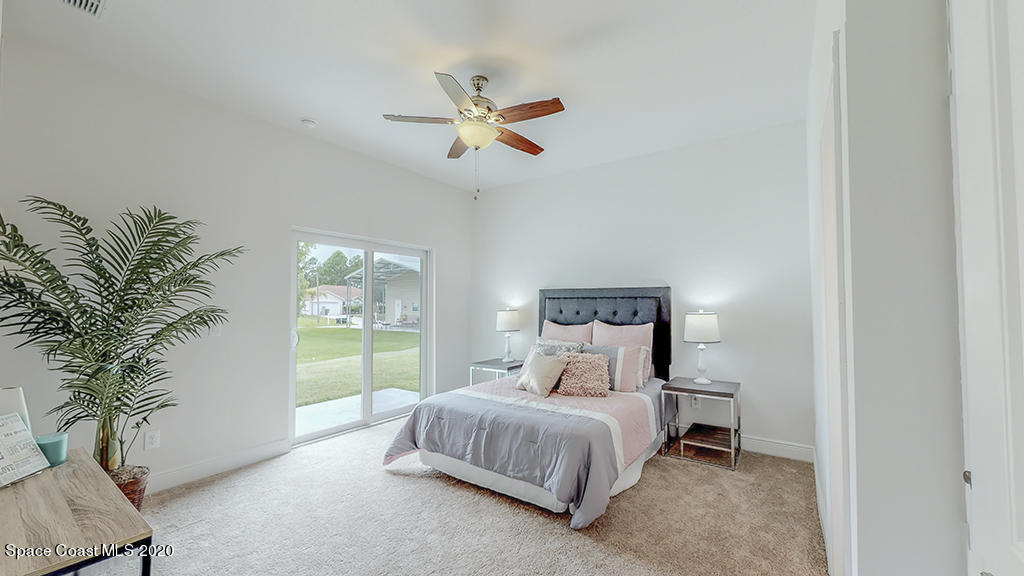 572 Corbin Circle Southwest Palm Bay, FL 32908 - Photo 9 of 32 a bedroom with a large bed and a window