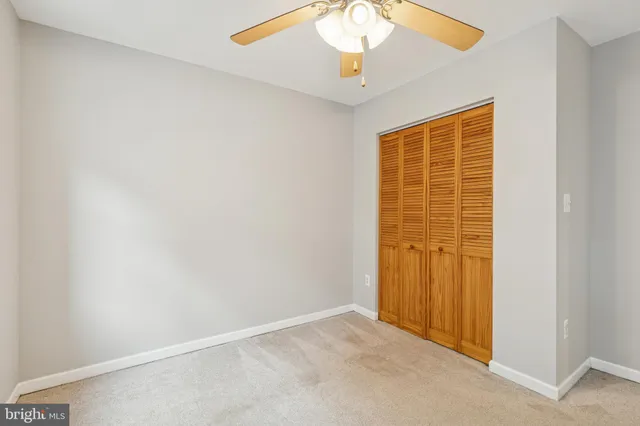 an empty room with a empty space and a ceiling fan