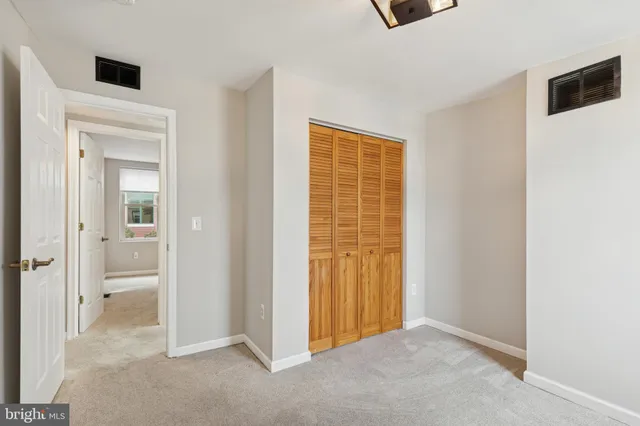 hallway with wooden floor and windows
