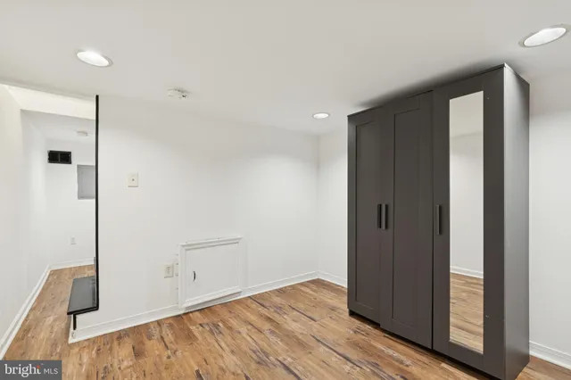 a view of empty room with wooden floor