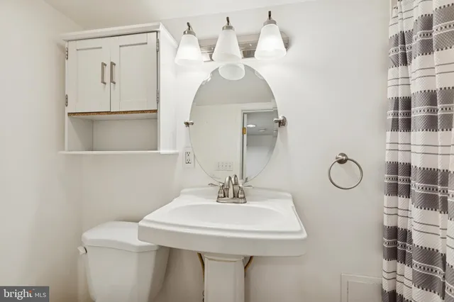 a bathroom with a sink a mirror and a shower
