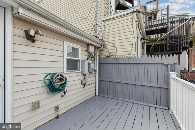 a view of a house with a wooden deck