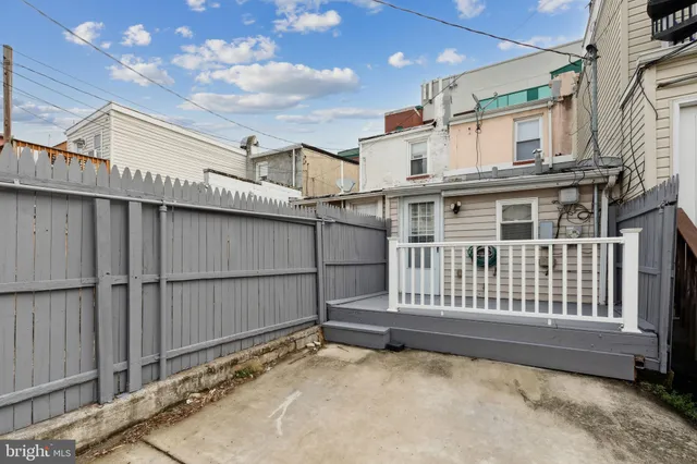 a view of a house with wooden fence