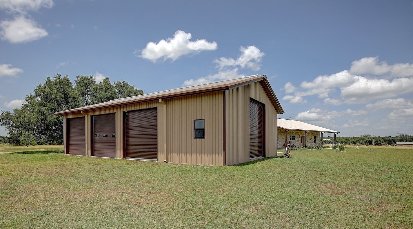 9414 Laird Road Round Top, TX 78954 - Photo 7 of 50 Metal barn/detached garage/workshop showing home location adjacent but not too far away