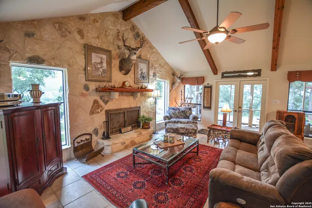 a spacious bedroom with a bed a dresser and chandelier