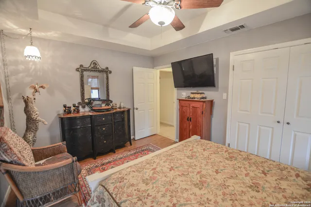 a view of a backyard with table and chairs under an umbrella